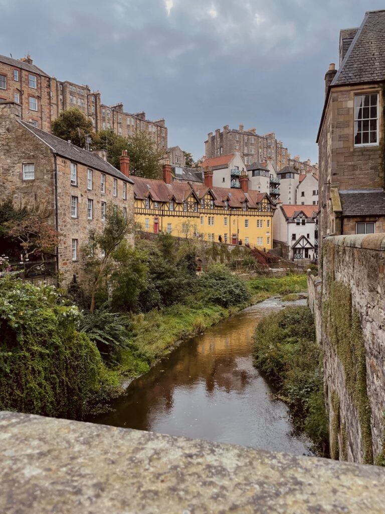 Dean’s Village - view of a village on a hill with brook in the foreground and buildings made from centuries-old stone masonry.