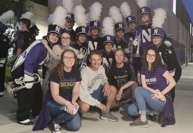 14 members and former members of Northwestern's mellophone section in band uniforms or NU t-shirts