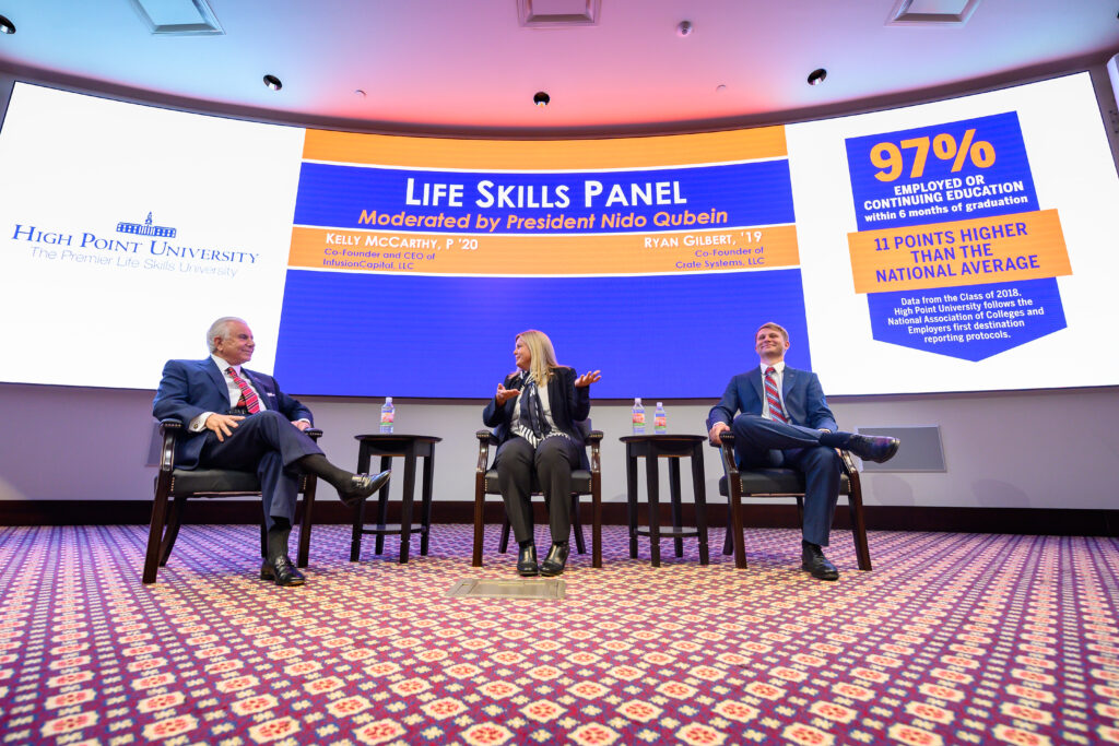 Three seated panelists in auditorium participating in a Life Skills Panel