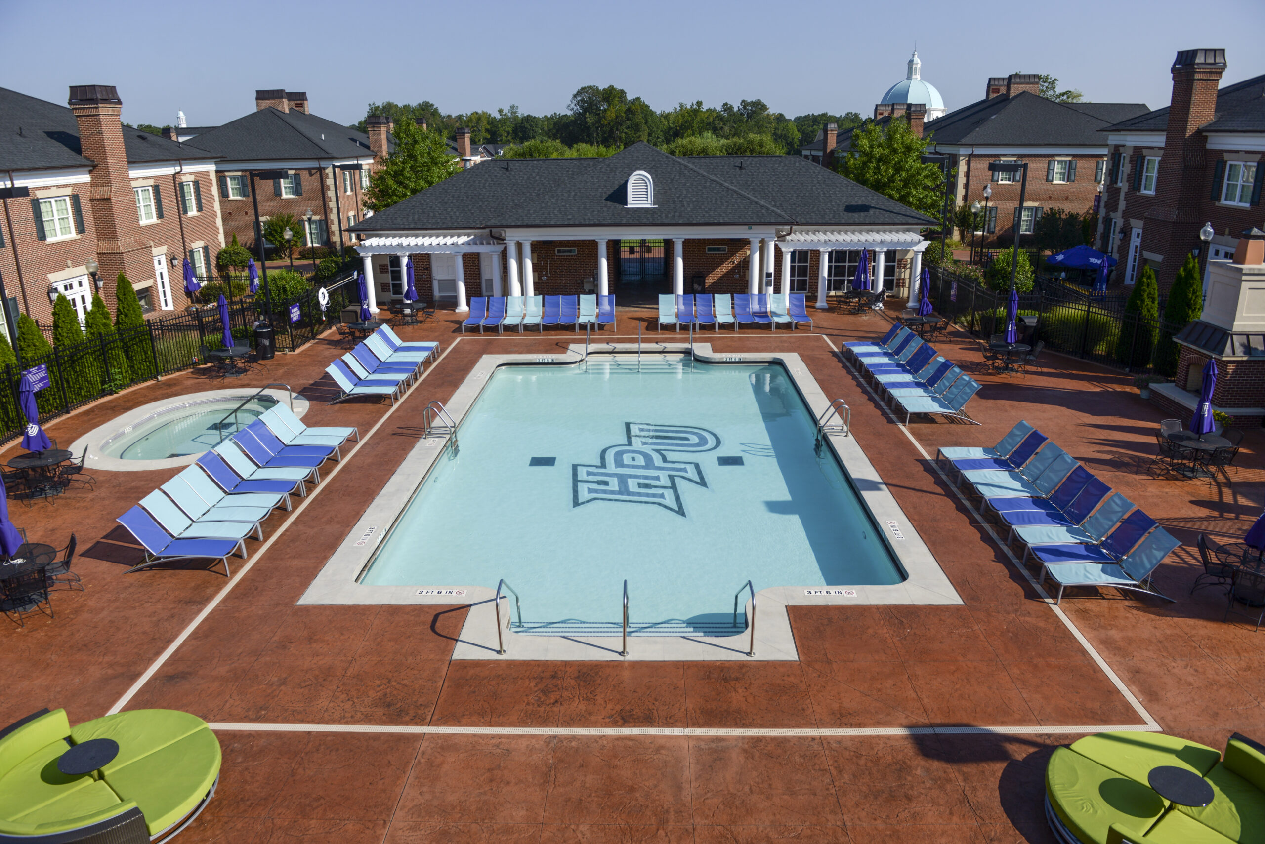 A swimming pool at High Point University surrounding by brick buildings