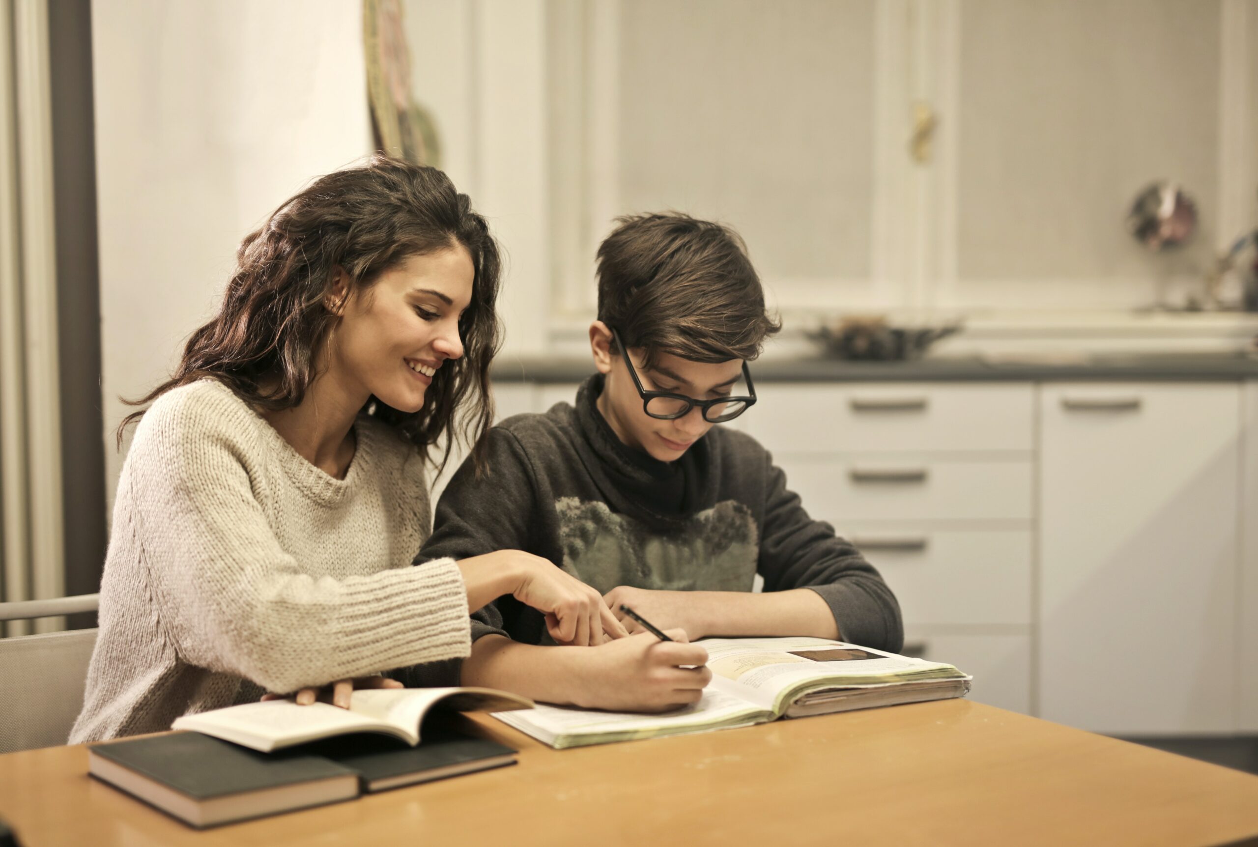 Female high school student helping younger student with homework