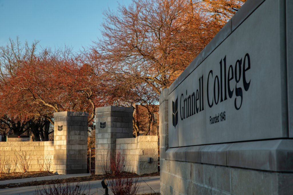 Grinnell College sign and columns in fall