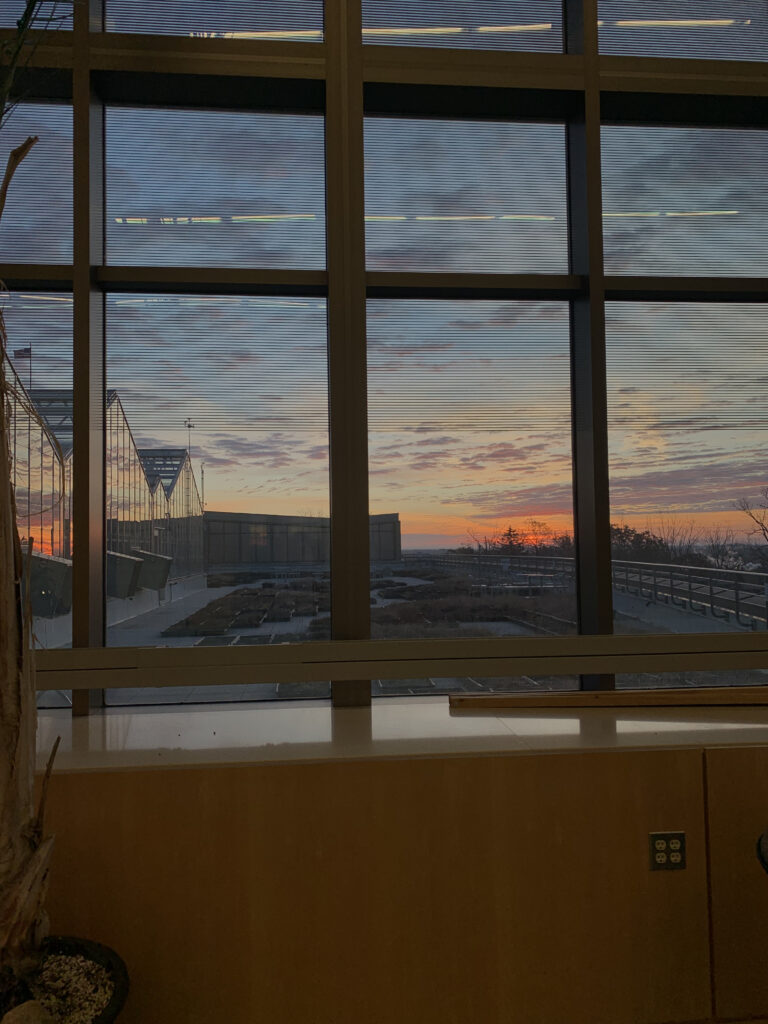 Sunrise over campus through Natural Science Building windows with panes