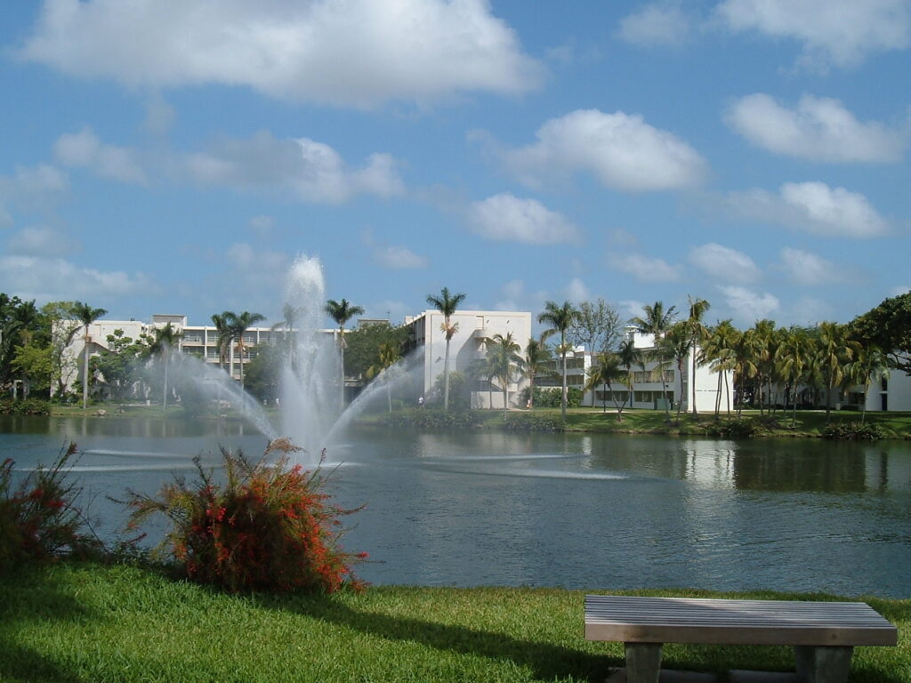 View of fountain on Lake Osceola with white campus buildings in background