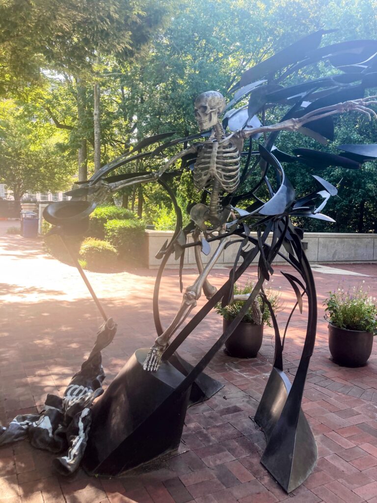 Skeleton mascot sculpture in outdoor plaza