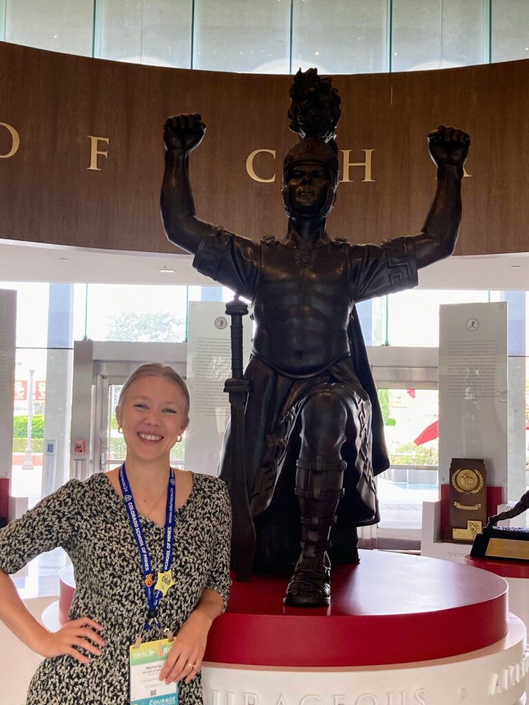 Michelle in front of the USC mascot, a trojan, in Heritage Hall